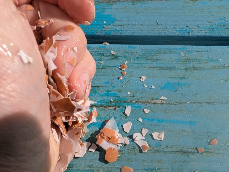 Crushing egg shells in hand. 