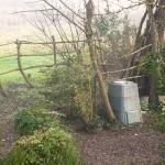 Compost bin in a misty garden.