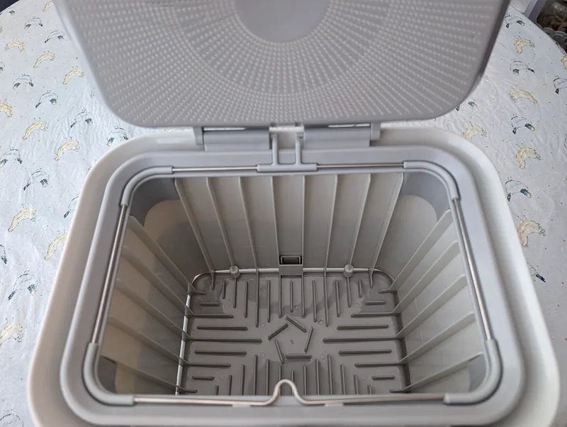 Ventilation holes are visible at the bottom of the Full Circle compost bin. 