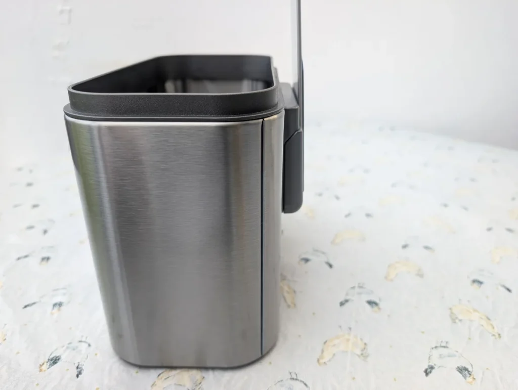 Mount on the back of the bin.