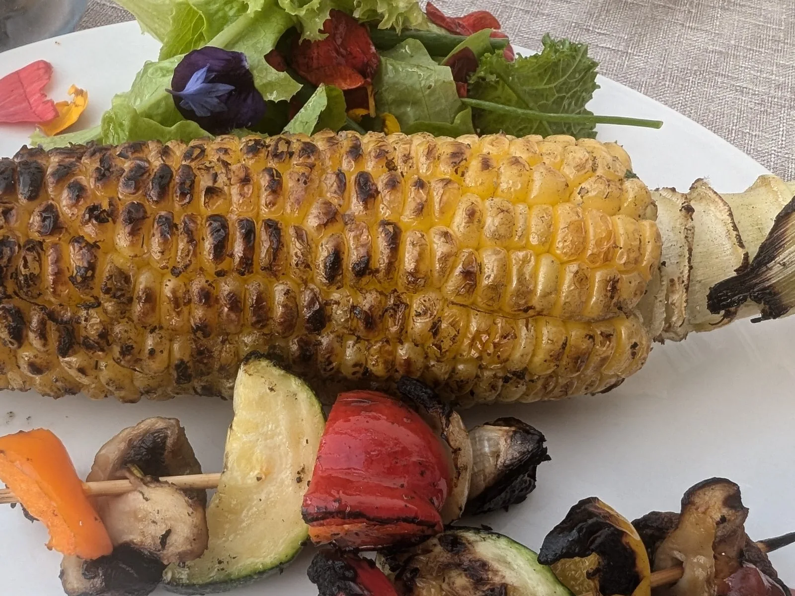 Home-grown sweetcorn, barbecued, with a skewer of garden vegetables